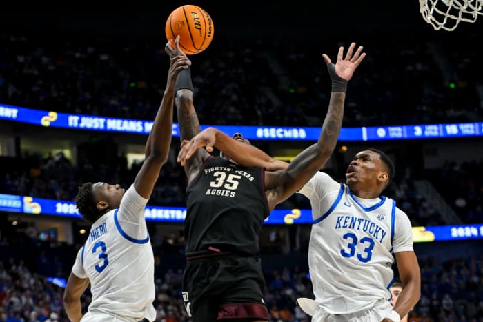 Mar 15, 2024; Nashville, TN, USA; Kentucky Wildcats forward Ugonna Onyenso (33) and guard Adou Thiero (3) block the shot of Texas A&M Aggies guard Manny Obaseki (35) during the first half at Bridgestone Arena. Mandatory Credit: Steve Roberts-USA TODAY Sports